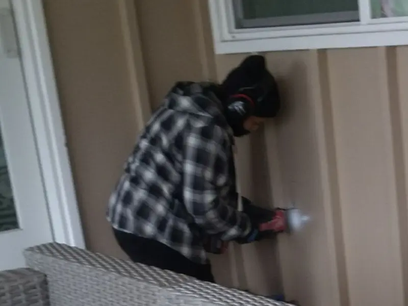 Professional electrician installing an exterior outlet in Porter